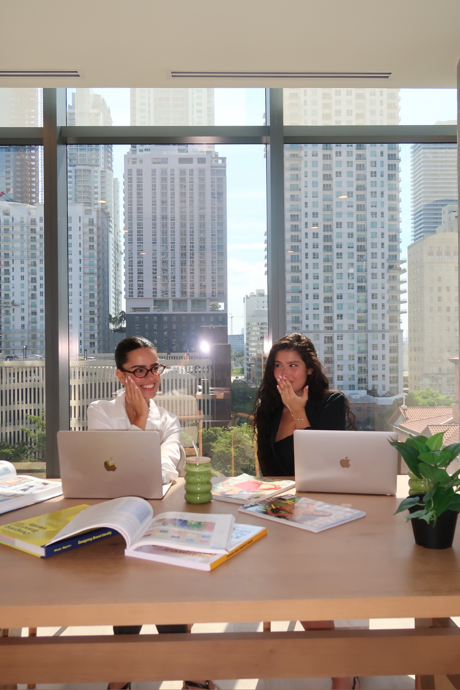 Ana and Giuliana smiling together at the Casa creative table