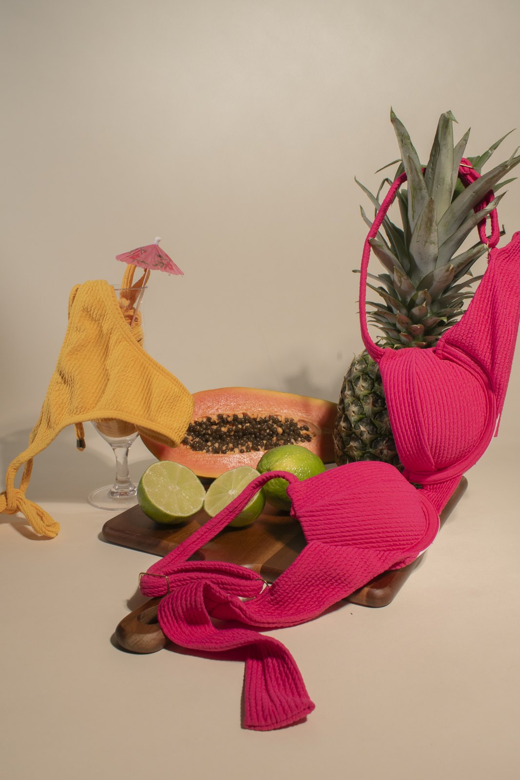 Colorful Merci Solei swimwear arranged in a tropical still life