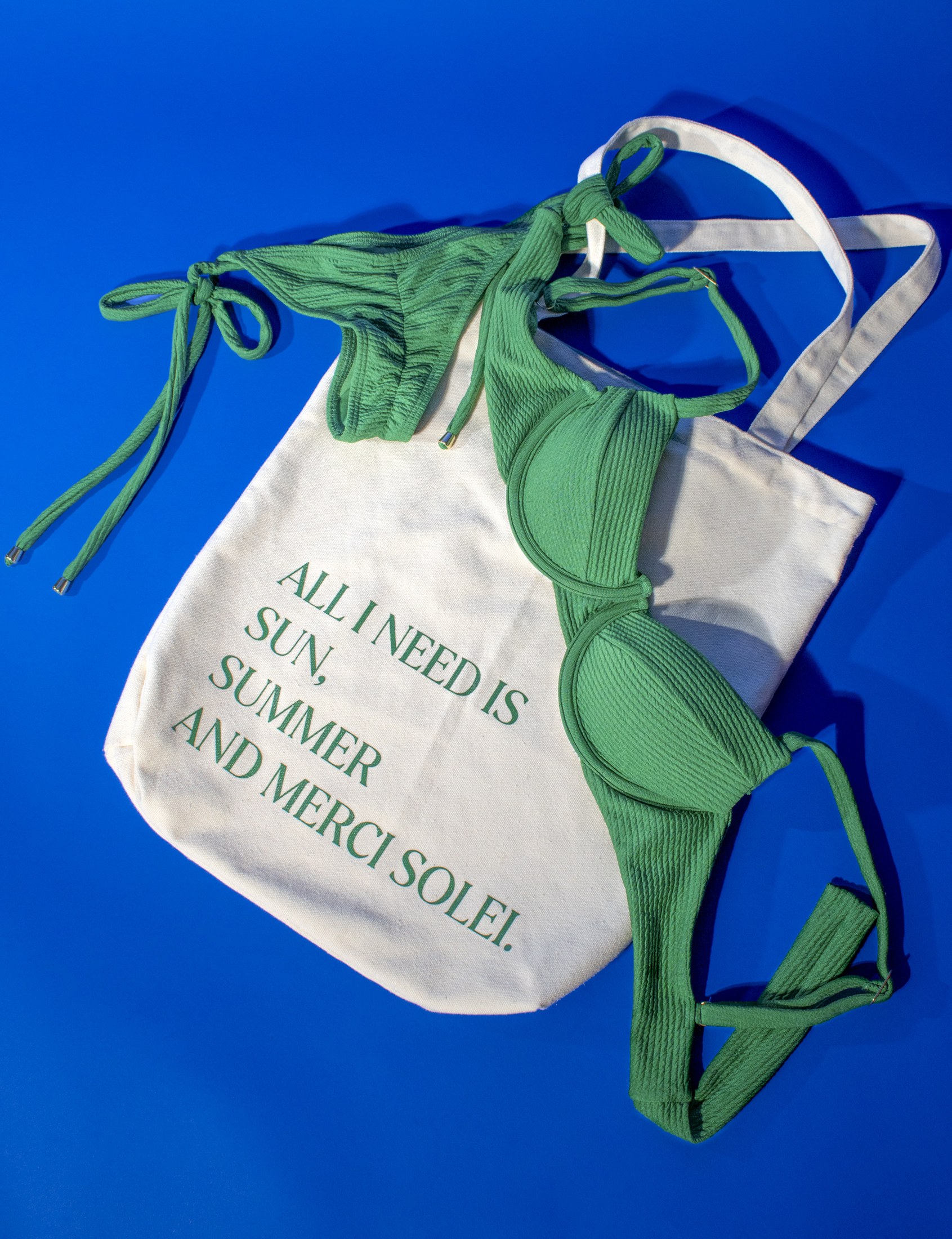 Merci Solei green swimwear with the branded summer tote